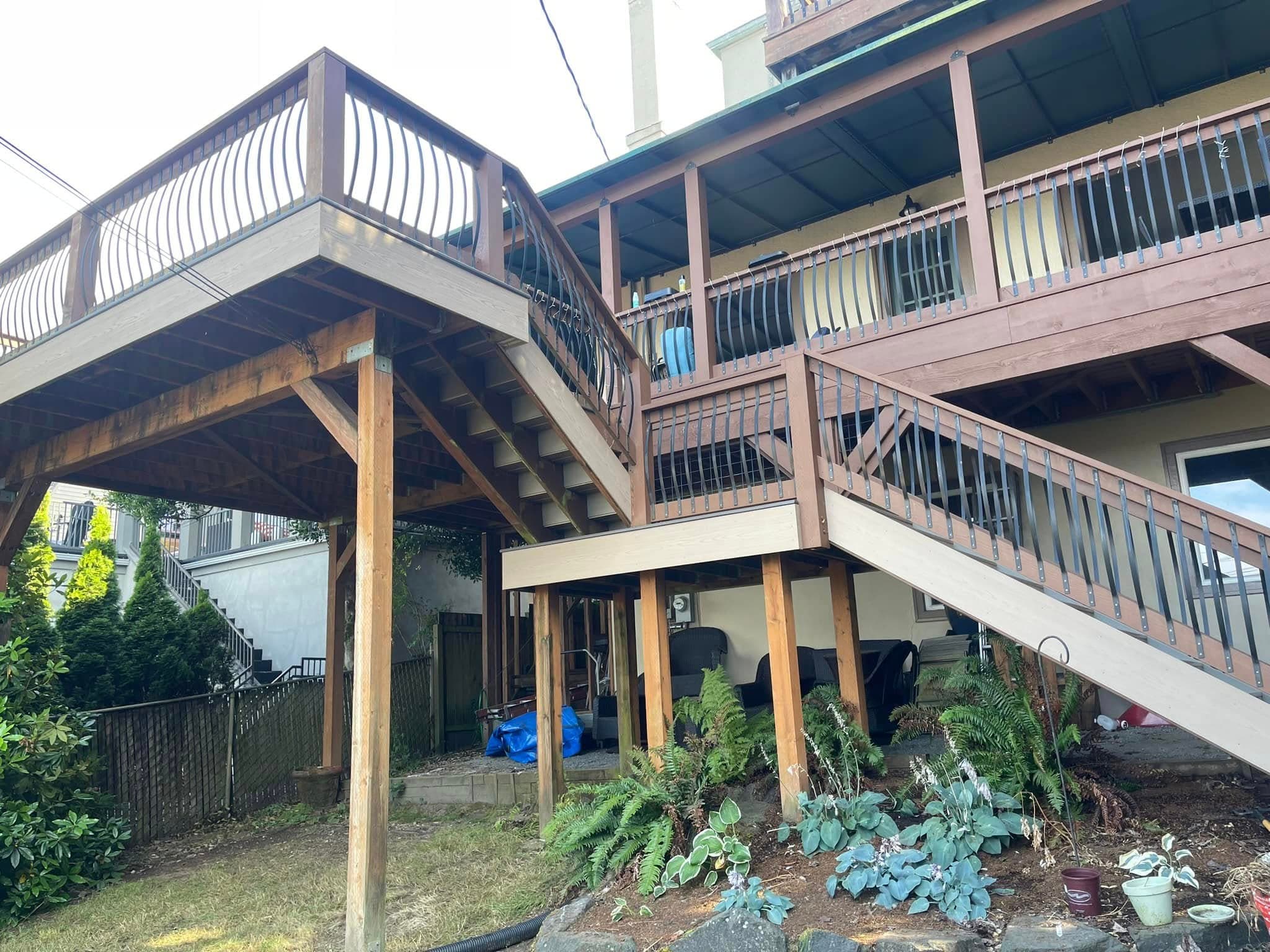 Multi-story deck and staircase with wood balusters by Ascend General Contractors