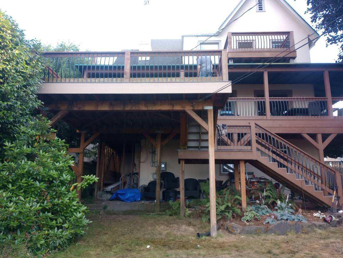 Multi-level deck under construction with framing and stair structure visible