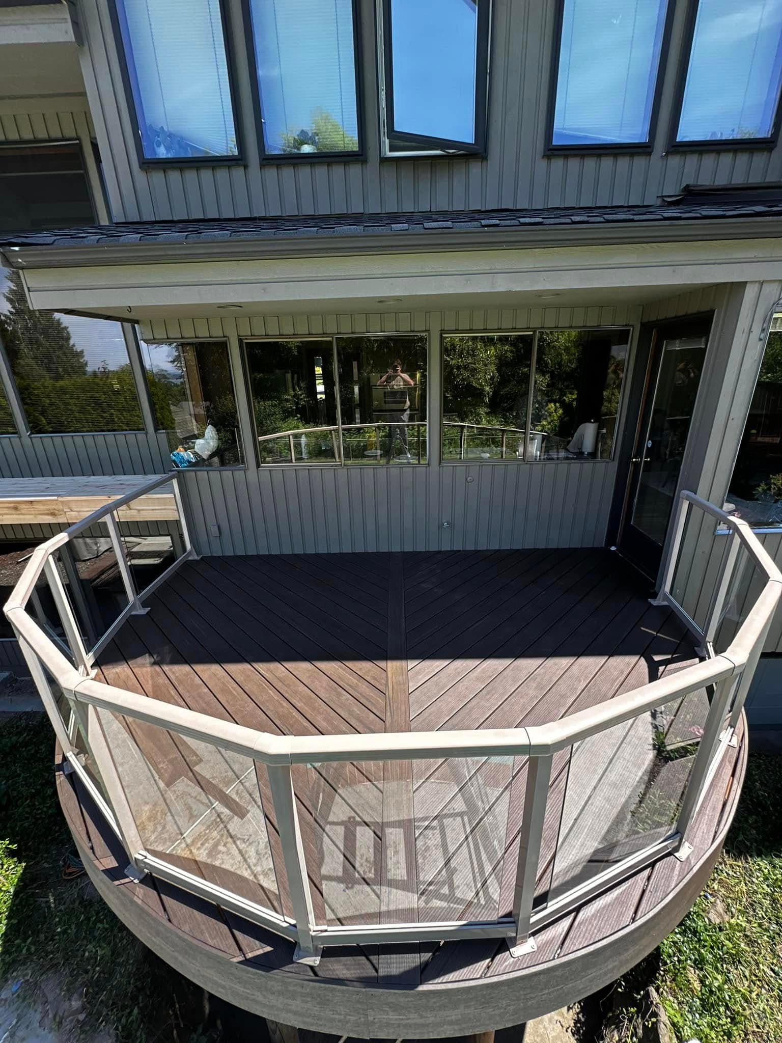 Hexagonal deck with glass and aluminum railing system on a Pacific Northwest home
